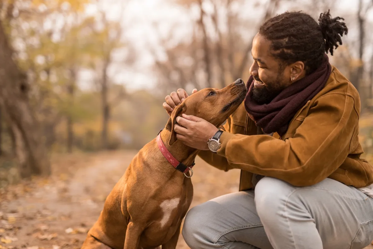 man in the woods with his dog