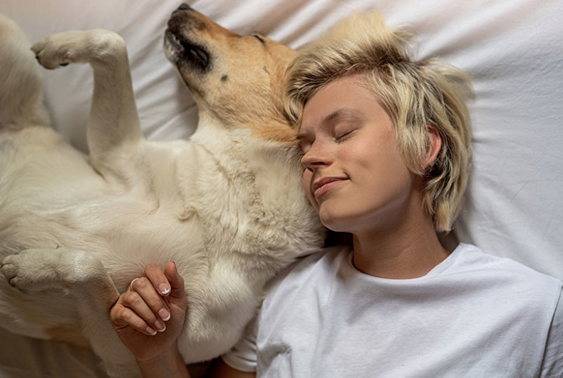 Dog sleeping with woman
