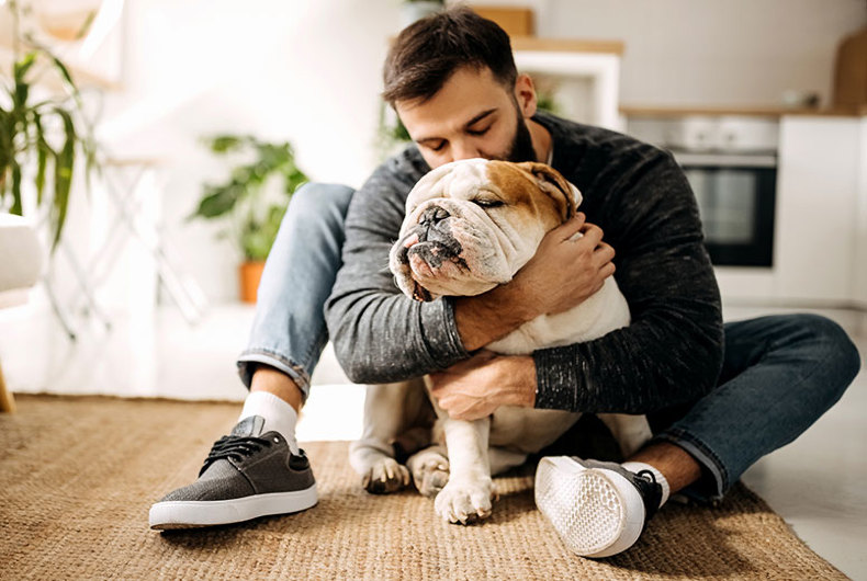 Man hugging his bulldog